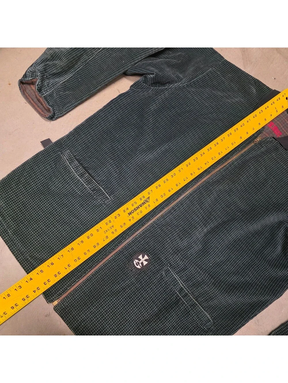 Schroff corduroy jacket features a distinctive green checkered pattern 25x34